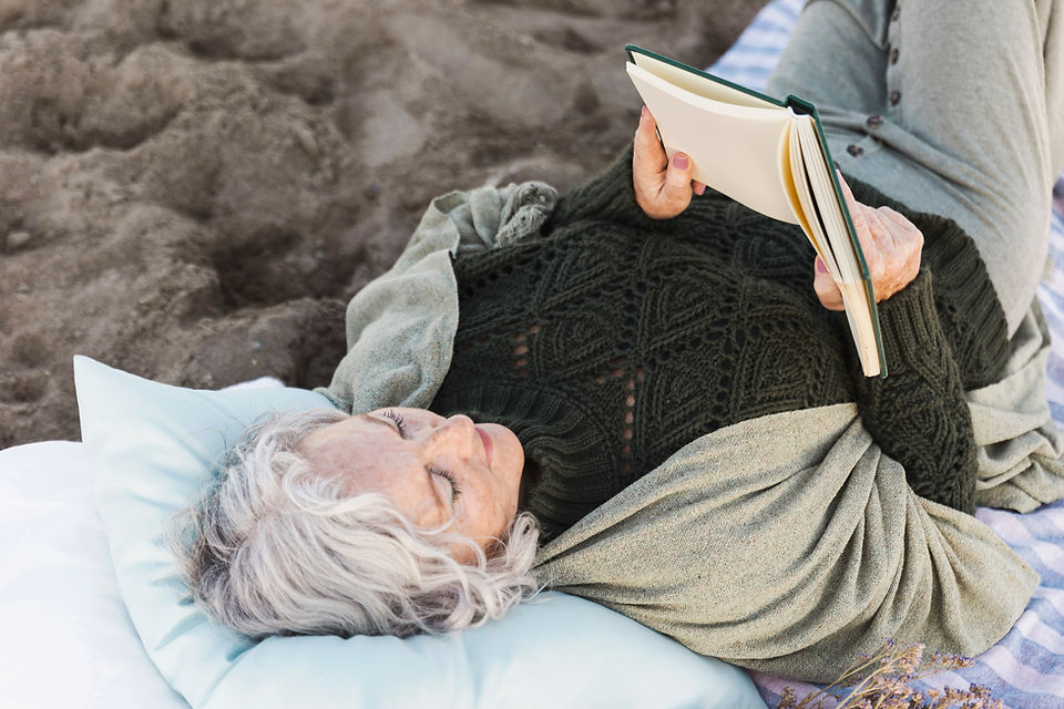 Surve Wellness a woman lying down and reading a book